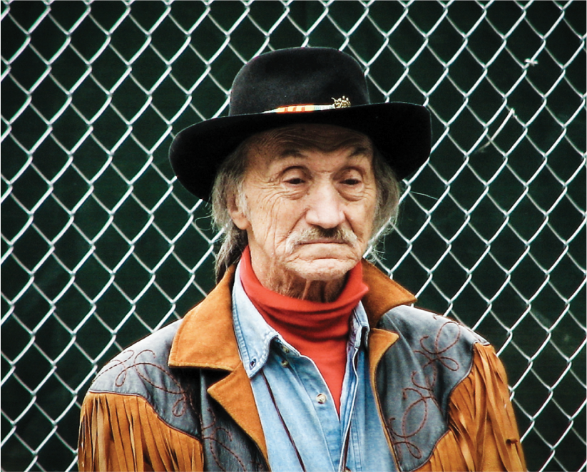 NY photography, americana photography, old man, leather coat, denim coat, red scarf, black hat, front of gate